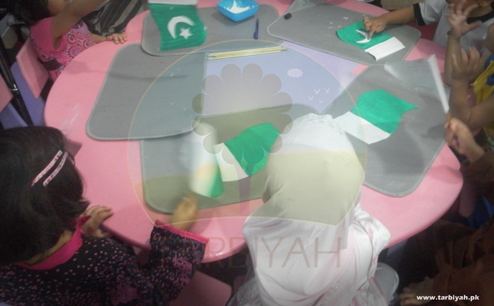Kids on table making Pakistan flag