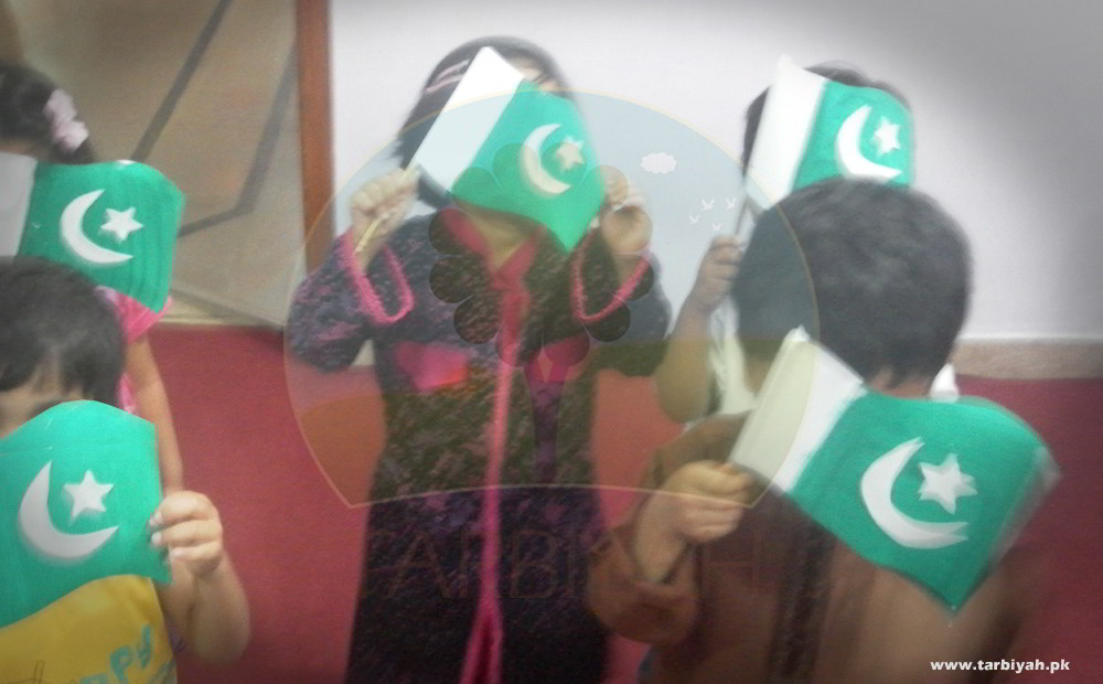 Kids standing with Pakistan flags